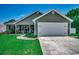 Charming single-story home with a well-manicured lawn, inviting front porch, and attached two car garage at 113 Adelphia Rd., Loris, SC 29569