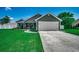 Beautiful exterior featuring manicured lawn and a two car garage at 113 Adelphia Rd., Loris, SC 29569