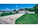 The front exterior shows a well-manicured lawn and a two-car garage at 113 Adelphia Rd., Loris, SC 29569