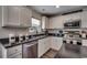 Well-lit kitchen featuring stainless steel appliances, white cabinetry, granite countertops, and a window at 113 Adelphia Rd., Loris, SC 29569