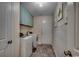 Functional laundry room with a washer, dryer, overhead cabinets, and stylish plank walls at 113 Adelphia Rd., Loris, SC 29569