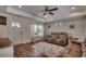 Inviting living room featuring a tray ceiling, shiplap accent wall, plush couches, and stylish decor at 113 Adelphia Rd., Loris, SC 29569