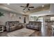 Bright living room featuring reclining couches, shiplap accents, modern lighting, and hardwood floors at 113 Adelphia Rd., Loris, SC 29569
