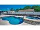 Beautiful backyard pool and spa with connecting waterfall and stone design, perfect for relaxation at 113 Adelphia Rd., Loris, SC 29569
