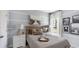 Serene bedroom with blue accents, a decorative headboard, and a window with sheer curtains at 1170 Silver Perch Place, Sunset Beach, NC 28468