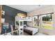 Stylish bedroom with a bunk bed, desk, and a bright window offering a view of the outdoors at 1170 Silver Perch Place, Sunset Beach, NC 28468