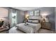 Serene bedroom featuring a plush bed, soft lighting, and a view of the water at 1170 Silver Perch Place, Sunset Beach, NC 28468