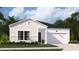 Charming single-story home featuring white siding, a black roof, and a well-manicured lawn at 1170 Silver Perch Place, Sunset Beach, NC 28468