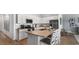 Modern kitchen with white cabinets, stainless steel appliances, and a center island with seating at 1170 Silver Perch Place, Sunset Beach, NC 28468