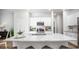 Well-lit kitchen with white cabinets, granite countertops, stainless steel appliances, and barstool seating at 1171 Silver Perch Place, Sunset Beach, NC 28468