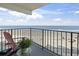 Relaxing balcony view of the beach, ocean, and a lounge chair with a small green plant at 1210 N Waccamaw Dr. # 305, Murrells Inlet, SC 29576