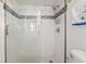 Modern bathroom showcasing glass enclosed shower and white subway tile with blue accent trim at 1210 N Waccamaw Dr. # 305, Murrells Inlet, SC 29576
