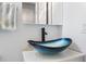 Close up of a glass bowl sink with a modern faucet in a well lit bathroom at 1210 N Waccamaw Dr. # 305, Murrells Inlet, SC 29576