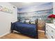 Cozy bedroom featuring ocean mural, wood floors, and coordinated bedding at 1210 N Waccamaw Dr. # 305, Murrells Inlet, SC 29576