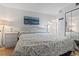 Comfortable bedroom featuring a queen-sized bed with coastal bedding, bedside tables and mirror closet at 1210 N Waccamaw Dr. # 305, Murrells Inlet, SC 29576