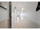 Hallway features tile flooring and white walls, illuminated by a wall-mounted light fixture and storage at 1210 N Waccamaw Dr. # 305, Murrells Inlet, SC 29576