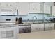 Charming kitchen featuring white appliances and cabinets, with a decorative dishwasher at 1210 N Waccamaw Dr. # 305, Murrells Inlet, SC 29576
