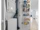 In-unit stacked washer and dryer with door featuring storage racks for laundry supplies at 1210 N Waccamaw Dr. # 305, Murrells Inlet, SC 29576
