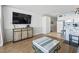A bright living room area with wood flooring and an open view of the kitchen at 1210 N Waccamaw Dr. # 305, Murrells Inlet, SC 29576