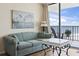 Comfortable seating area with ocean view, painting of ships, and stylish decor at 1210 N Waccamaw Dr. # 305, Murrells Inlet, SC 29576