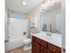 Bright bathroom with a wooden vanity, mirror and shower-tub combo, offering comfort and style at 1217 Cymmer Ct., Conway, SC 29527