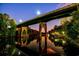 Scenic view of a bridge over a calm river at dusk, with lush trees and reflections in the water at 1217 Cymmer Ct., Conway, SC 29527