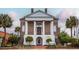 Historic City Hall building with brick facade, white columns, and well-manicured gardens and trees at 1217 Cymmer Ct., Conway, SC 29527