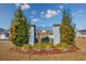Welcoming New Castle community entrance featuring stone pillars, lush landscaping, and a clear view of homes at 1217 Cymmer Ct., Conway, SC 29527