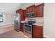 Cozy kitchen featuring stainless steel appliances and rich wood cabinetry at 1217 Cymmer Ct., Conway, SC 29527
