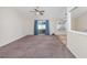 Open-concept living room with carpet, sliding glass doors with curtains, and views into the kitchen and dining area at 1217 Cymmer Ct., Conway, SC 29527