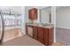 Convenient wet bar area with granite countertops, stainless steel dishwasher, and cherry cabinets open to dining area at 1217 Cymmer Ct., Conway, SC 29527