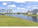 Scenic backyard view showcasing a serene pond surrounded by lush greenery at 122 New Paradise Way, Myrtle Beach, SC 29588