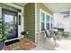 Charming front porch with seating, plants, and a welcoming entrance at 122 New Paradise Way, Myrtle Beach, SC 29588
