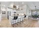 Bright kitchen boasts white cabinets, stainless appliances, black marble counters, and a spacious island at 122 New Paradise Way, Myrtle Beach, SC 29588