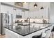 Spacious kitchen with black marble countertops, stainless steel appliances and white cabinets at 122 New Paradise Way, Myrtle Beach, SC 29588
