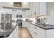 Modern kitchen features black marble counters, stainless steel appliances, and white cabinetry at 122 New Paradise Way, Myrtle Beach, SC 29588