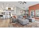 Open-concept living space with island seating, flows into a comfortable living room with a sectional couch and area rug at 122 New Paradise Way, Myrtle Beach, SC 29588