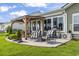 Relaxing outdoor patio with comfortable seating, a grill, and a view of the yard at 122 New Paradise Way, Myrtle Beach, SC 29588