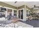 Inviting covered patio with comfortable seating, sliding glass doors, and stylish decor at 122 New Paradise Way, Myrtle Beach, SC 29588