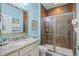 Well-lit bathroom with a granite countertop vanity, a framed mirror, and a glass-enclosed shower at 1290 Prescott Circle, Myrtle Beach, SC 29577