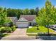 Charming single-story home with well-manicured lawn, lush trees, and attached two-car garage at 1290 Prescott Circle, Myrtle Beach, SC 29577