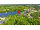 Aerial view of a house in community close to a lake, forest, and other houses at 131 Sago Palm Dr., Myrtle Beach, SC 29579
