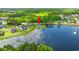 Aerial view showcases home near a lake, lush green trees, and other residences at 131 Sago Palm Dr., Myrtle Beach, SC 29579
