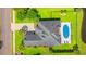Aerial view of a house with a pool and a well-manicured backyard surrounded by lush landscaping at 131 Sago Palm Dr., Myrtle Beach, SC 29579