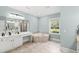 Bright bathroom featuring double sink vanity, jacuzzi tub, and walk-in shower at 131 Sago Palm Dr., Myrtle Beach, SC 29579