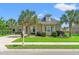 Charming home with lush landscaping, mature palm trees, and a well-manicured lawn at 131 Sago Palm Dr., Myrtle Beach, SC 29579
