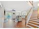 Open-concept living area with a staircase and seamless access to outdoor spaces at 131 Sago Palm Dr., Myrtle Beach, SC 29579