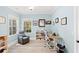 Bright home office with natural light, desk, shelving and comfortable seating at 131 Sago Palm Dr., Myrtle Beach, SC 29579