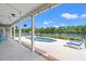 Charming covered patio features string lights, dining set, and a peaceful lake view at 131 Sago Palm Dr., Myrtle Beach, SC 29579