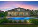 Backyard features a sparkling pool, a covered patio with string lights, and well manicured landscaping at 131 Sago Palm Dr., Myrtle Beach, SC 29579